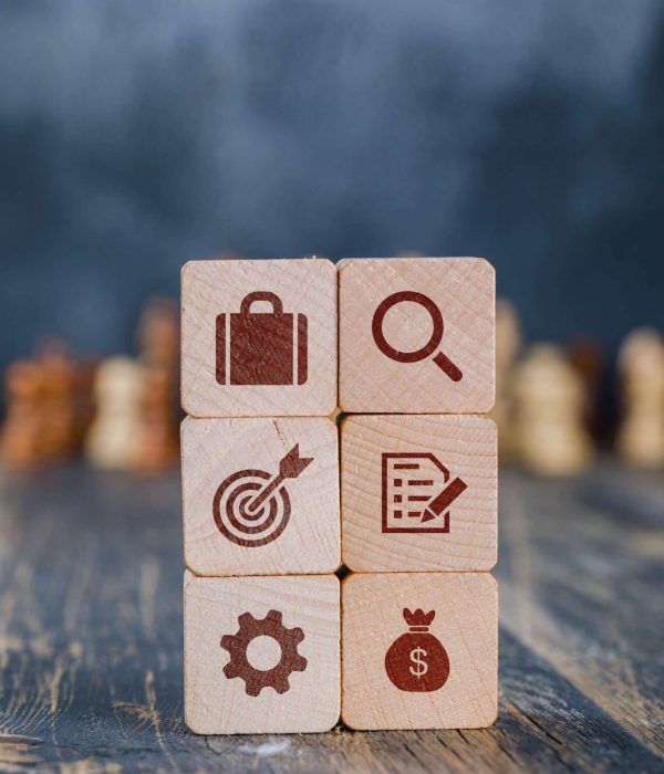 Business strategy concept with wooden cubes, chess figures on gloomy and wooden background side view.