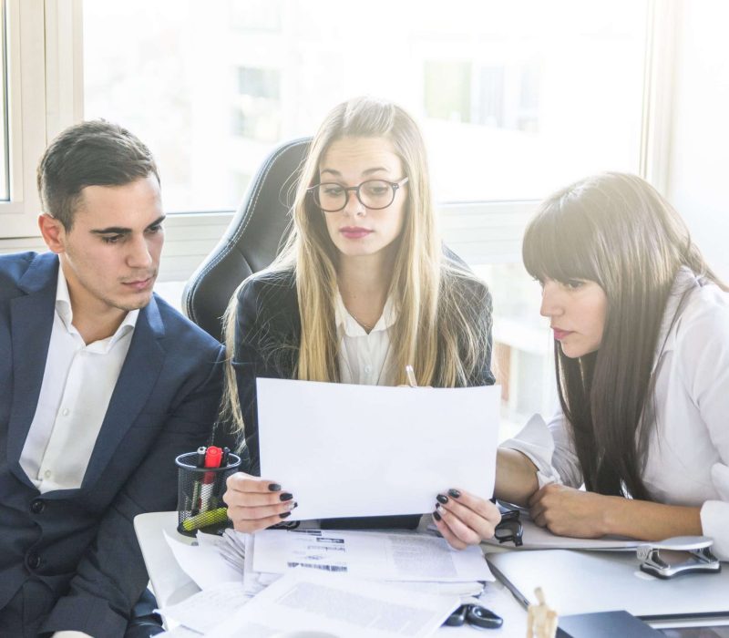 businesspeople-looking-document-office