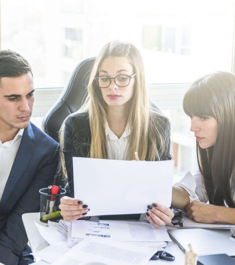 businesspeople-looking-document-office