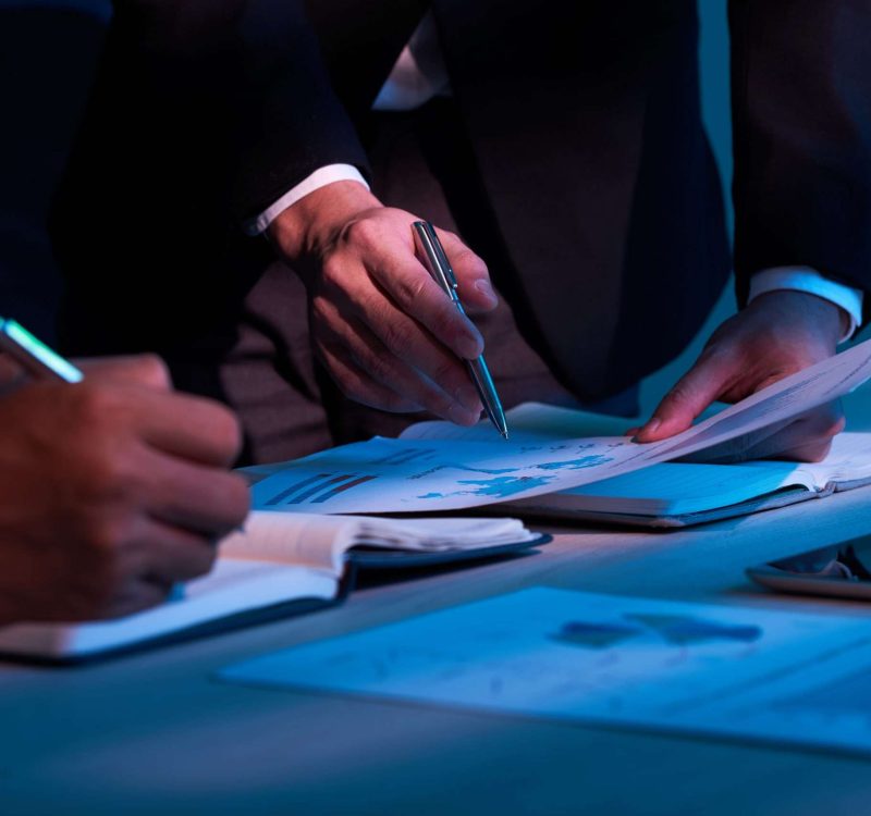 Close-up image of business partners working with financial documents