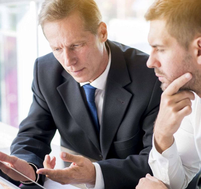 two-businessman-discussing-business-plan-digital-tablet