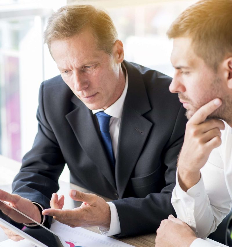 two-businessman-discussing-business-plan-digital-tablet